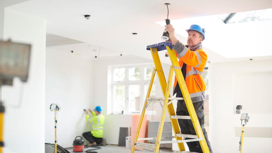 electrician installing downlights