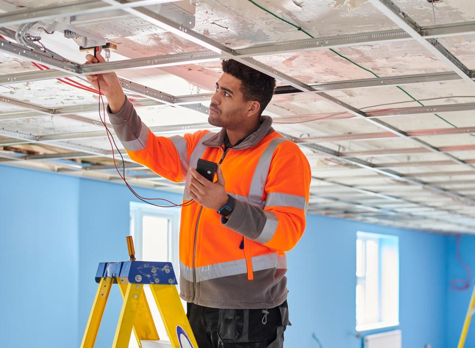 ctricians testing ceiling fixtures